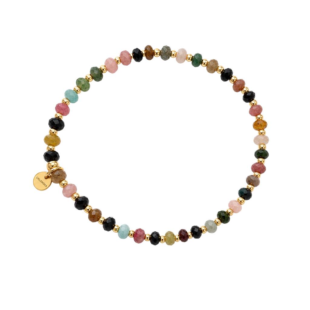 A beaded stretch bracelet featuring a variety of colorful gemstone beads in pink, green, black, brown, and light blue, separated by small gold spacer beads, with a small round gold tag on one side, shown on a plain white background.